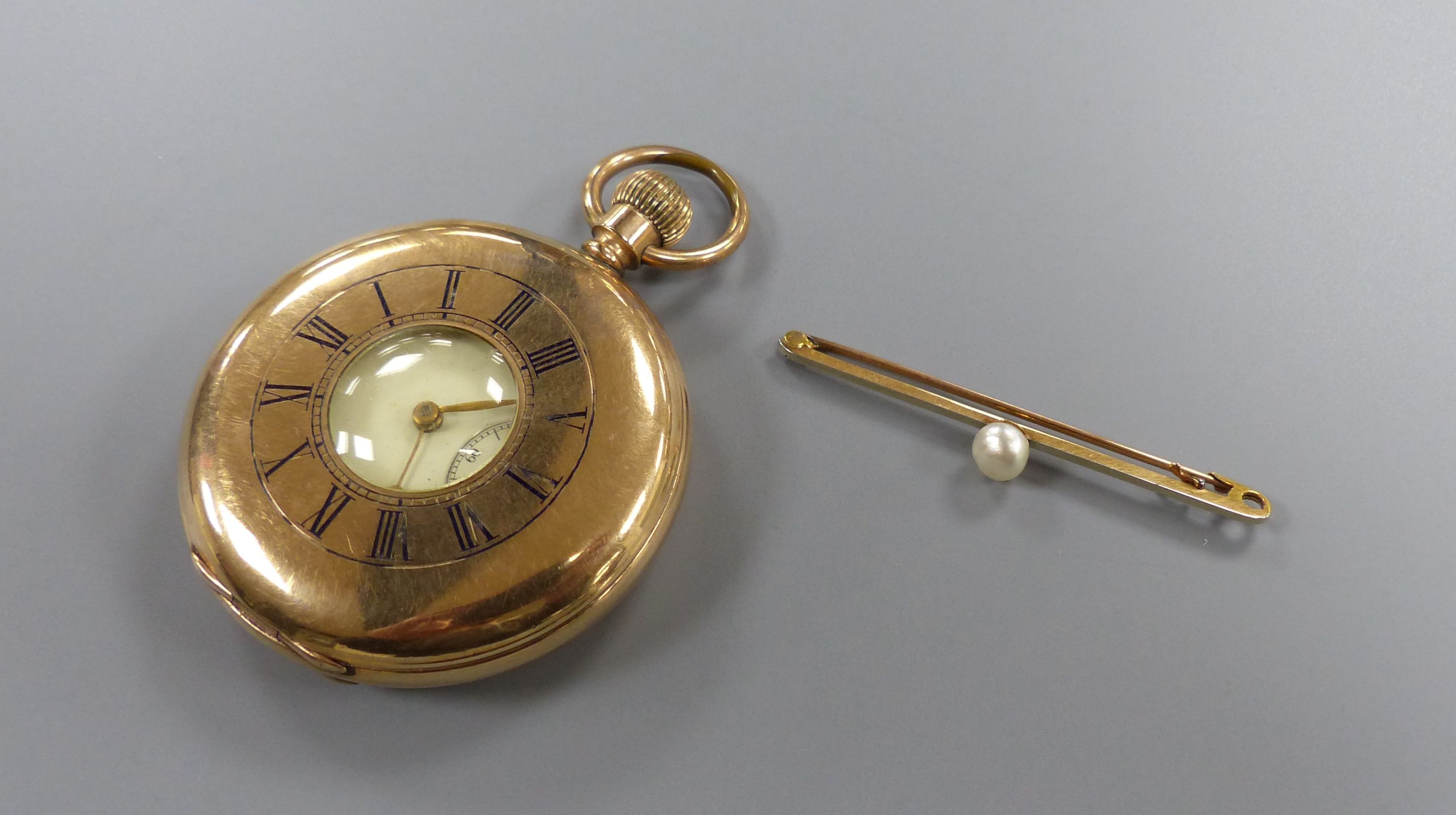 A gold plated half hunter pocket watch and a 375 and cultured pearl set tie pin, 55mm.